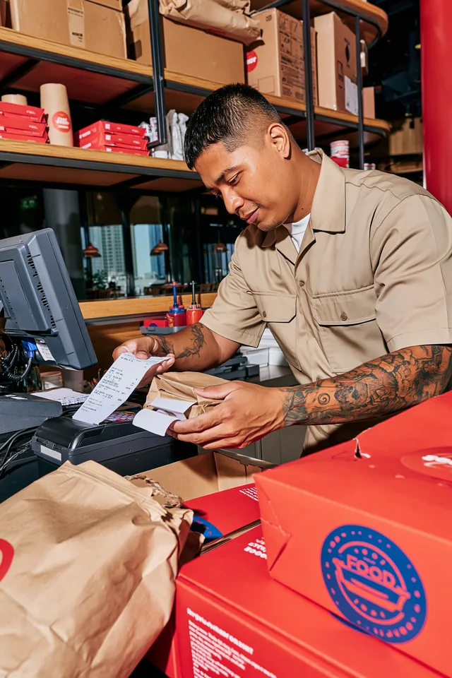 Restaurant operator preparing takeaway orders.